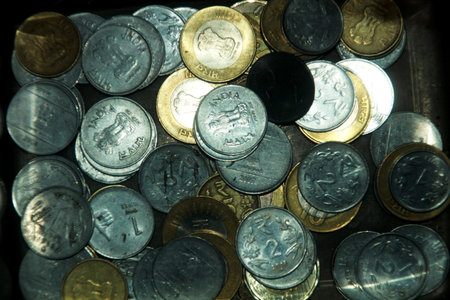 Pile of various Indian currency coins in background. Selective focus of coinsの写真素材