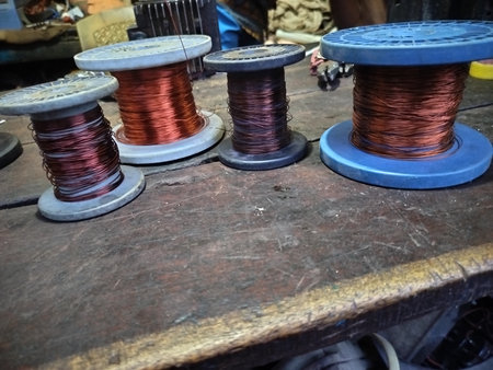 Collection of copper wire, cable in reels at workshop. Winding copper wire Close up. Different size and quality copper winding wireの写真素材