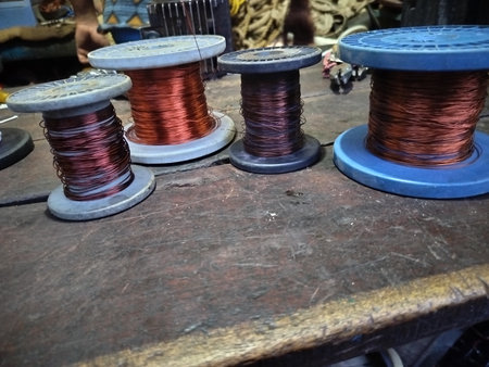 Collection of copper wire, cable in reels at workshop. Winding copper wire Close up. Different size and quality copper winding wireの写真素材
