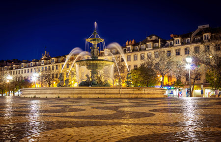 Fountain in Rossio square Lisbon at night time, Portugalの写真素材