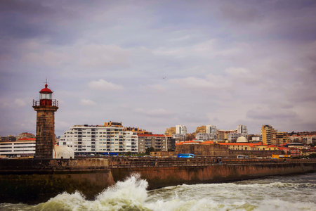 Old lighthouse and granite pier at the mouth of Douro river in Porto, Portugalのeditorial素材