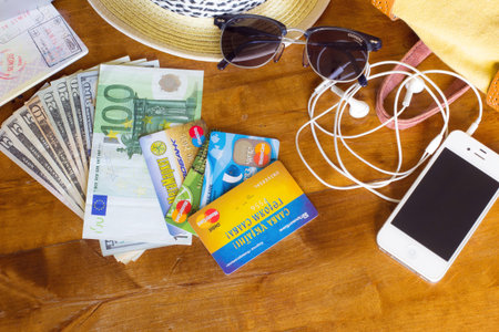 KYIV, UKRAINE - MAY 20, 2016: Different objects for traveling with credit cards on wooden backgroundのeditorial素材