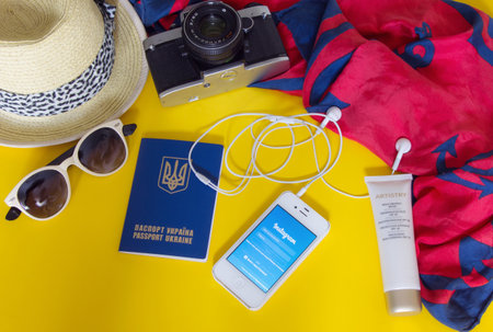 KYIV, UKRAINE - MAY 20, 2016: Different objects for traveling with Instagram on yellow backgroundのeditorial素材