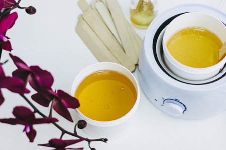 Orchid flower, aromatic sticks and paste for sugaring in beauty salonの写真素材