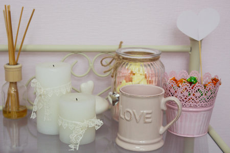 Candles, cup, aroma sticks and sweets on the table in beauty salonの写真素材