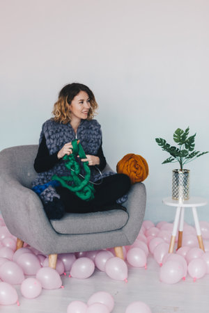 Young beautiful woman knittig green merino woolの写真素材