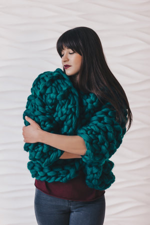 Beautiful young woman in green knitted merino wool cardiganの写真素材