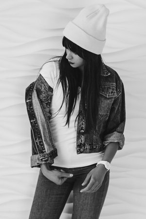 Black and white portrait of beautiful young woman dressing in 90s style fashionの写真素材