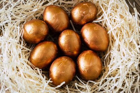 Golden Easter eggs in the straw