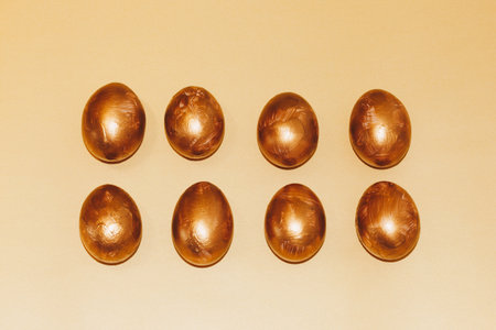 Two rows of golden Easter eggsの写真素材