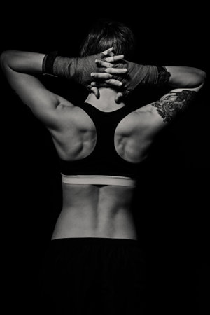 Beautiful muscular back of a boxer woman. Black and white shotの写真素材