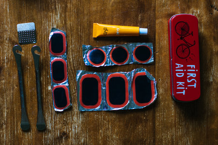 Bicycle repair kit on wooden background. Top viewの写真素材