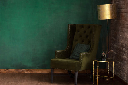 Stylish green room with arm-chair and lampの写真素材