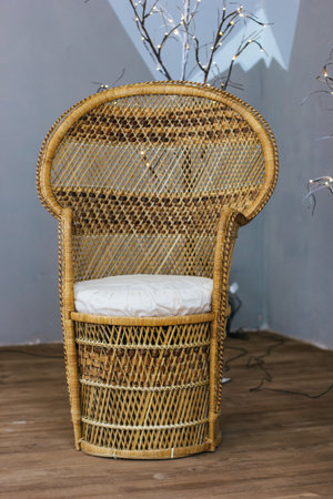 Interior with cane-chair and grey wall