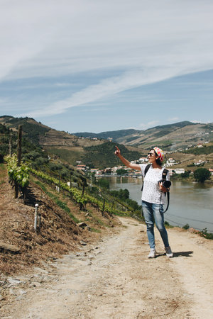 Young woman photographer walking in beautiful vineyards of Pinhao village in Portugalの写真素材