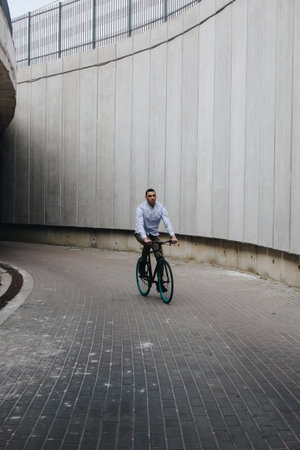 Mixed race hipster man riding bicycleの写真素材