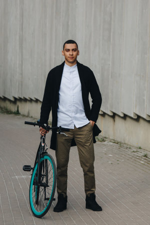 Mixed race hipster man posing with bicycleの写真素材