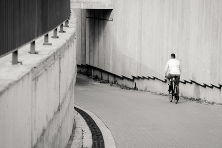 Mixed race hipster man riding bicycle. Black and white shotの写真素材