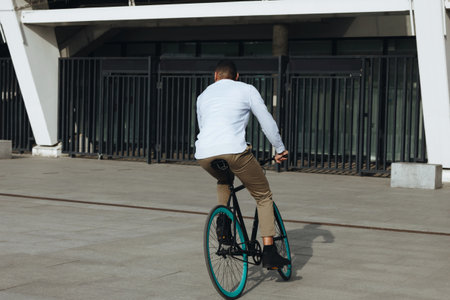Mixed race hipster man riding a bicycle in the city