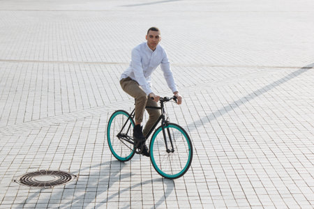 Mixed race hipster man riding a bicycle in the cityの写真素材