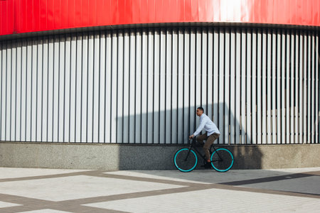 Mixed race hipster man riding a bicycle in the cityの写真素材