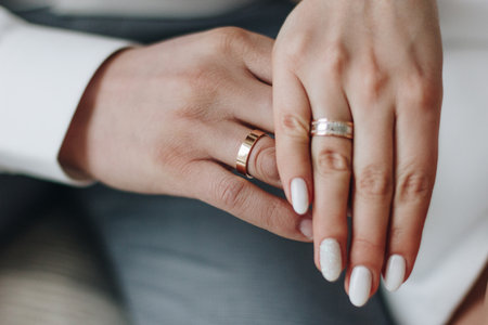Groom and and bride hands with rings, close upの写真素材