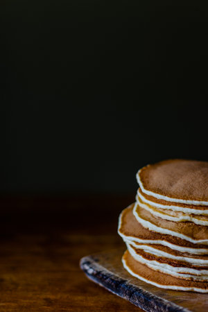 Stack of pancakes on wooden boardの写真素材