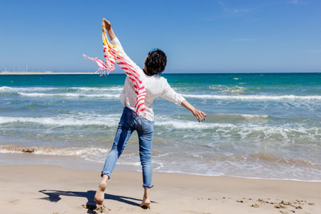 Beautiful Young Woman With Colorful Scarf on The Beachの写真素材