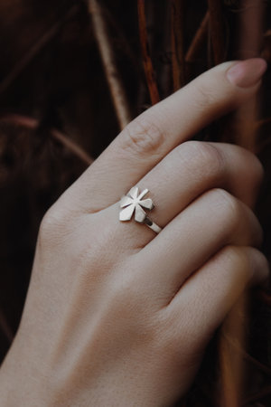 Close up of woman hand with silver chestnut leaf shape ring