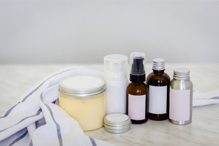 Cosmetic bottles and containers with blank label for branding mock-up on marble tableの写真素材