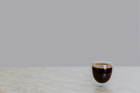 Glass with coffee on marble tableの写真素材