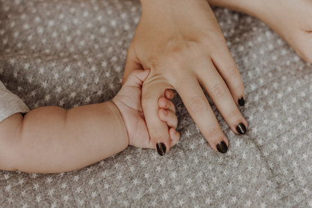 Newborn baby holding mother handの写真素材