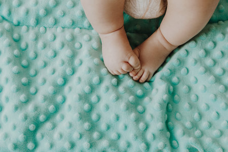 Small baby legs on green plaidの写真素材