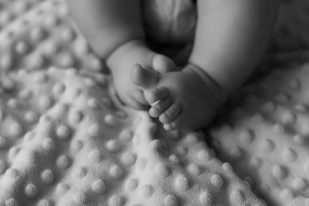 Small baby legs on plaidの写真素材