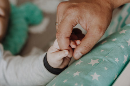 Newborn baby holding father handの写真素材