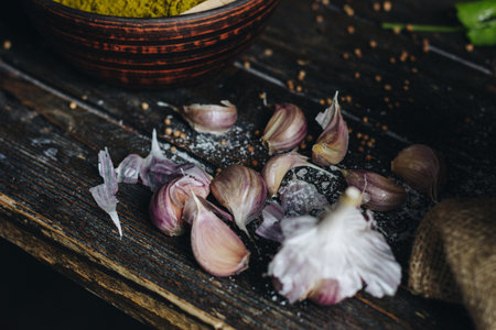 Garlic and coriander on wooden tableの写真素材