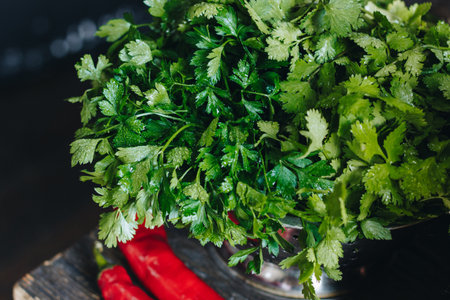 Parsley and red hot peppers on wooden table