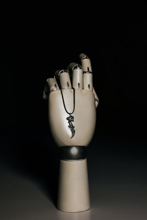 Robot hand with silver pendantの写真素材