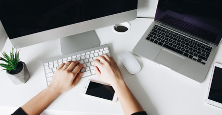 Top view of woman using computer at home workplaceの写真素材
