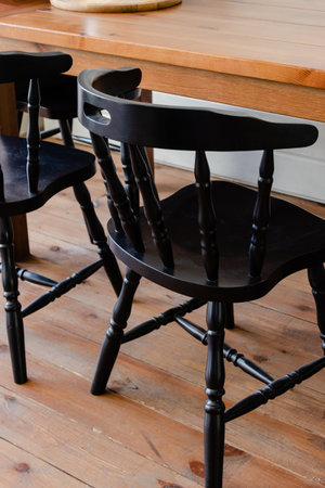 Black wooden kitchen chair near the tableの写真素材
