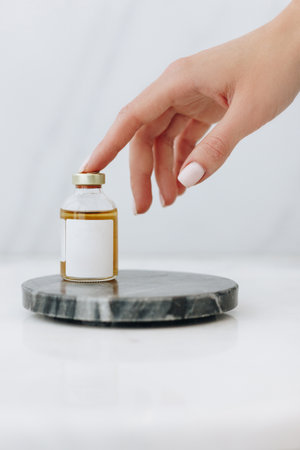 Medicine bottle with woman handの写真素材