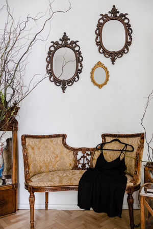 Vintage sofa in studio room with black silk dress