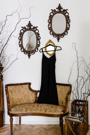Vintage sofa in studio room with black silk dressの写真素材