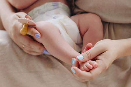Mother holding baby feet in her handsの写真素材