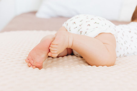 Small baby legs on beige plaidの写真素材