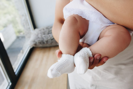 Father holding baby feet in his handsの写真素材