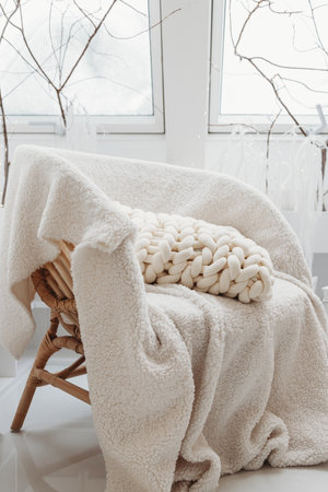 Chunky Knit White Pillow on the chairの写真素材