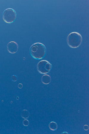 Natural Soap Bubbles Floating on Blue Sky Backgroundの写真素材