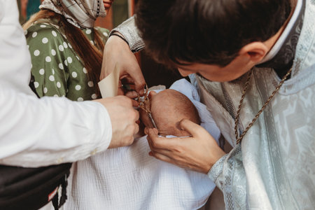 The sacrament of baptism. Newborn baby during christeningの写真素材