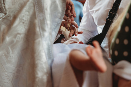The sacrament of baptism. Newborn baby during christeningの写真素材